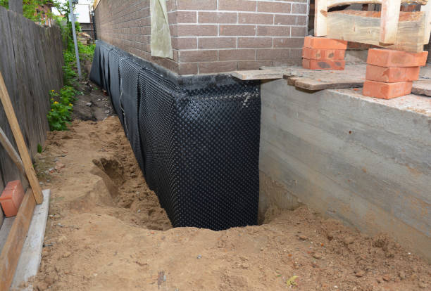 Happy homeowners after waterproofing job in Brownsville